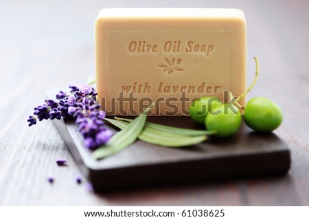 bar of herbal soap with fresh herbs and olives - beauty treatment