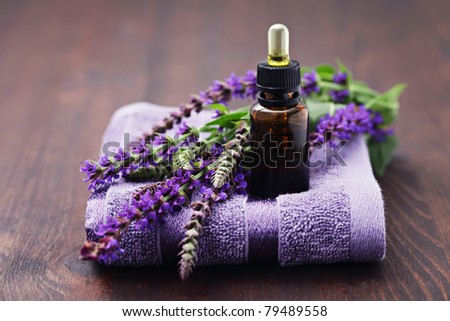 sage essential oil with fresh sage and towel - beauty treatment
