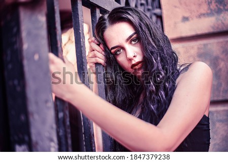 Image, Stock Photo Sad girl portrait clinging to a gate