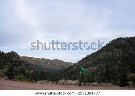 Similar – Image, Stock Photo Man admiring mountain landscape from wooden footbridge