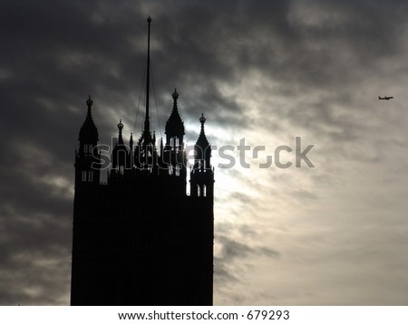 Parliament tower silhouette view with dappled clouds and sun evening