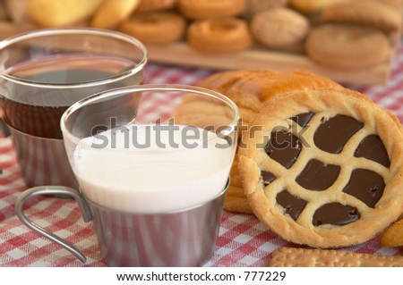 Cereal biscuits, chocolate cake, and a cup of milk: Italian style breakfast