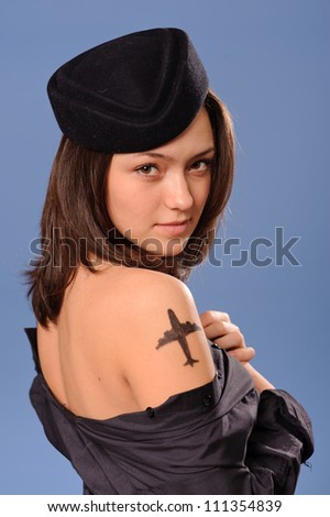 Portrait of a beautiful young flight attendant with tattoo