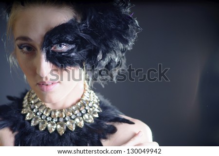 portrait of sexy woman with black feather half mask for Venice desire concept