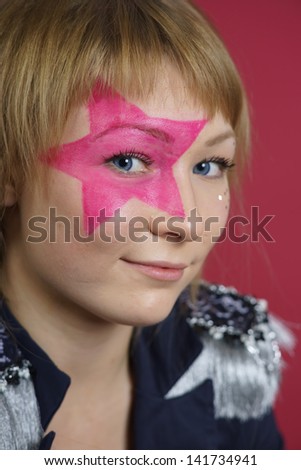 Pretty young teenager with pink star on the face