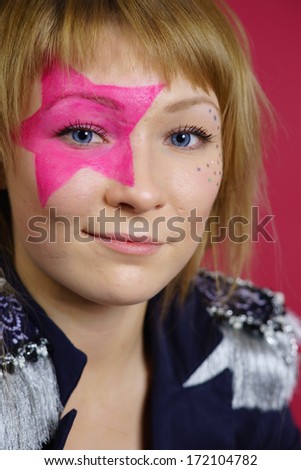 Pretty young teenager with pink star on the face