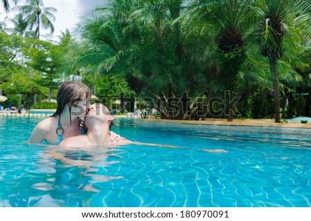 kissing couple in water pool