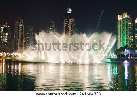 DUBAI - OCT 15: The Dubai Fountain on October 15, 2014 in Dubai, UAE. The Dubai Fountain is the world\'s largest choreographed fountain system set on the 30-acre manmade Burj Khalifa Lake