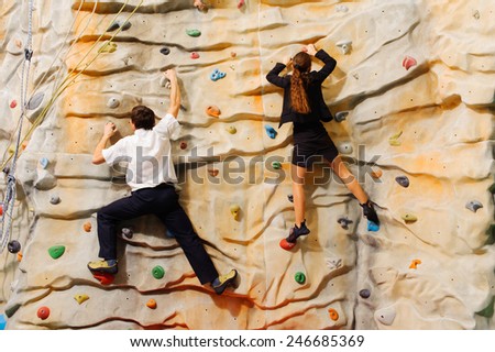 Competition between business partners on man-made cliff in the sport centre