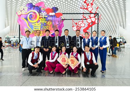 SHENZHEN, CHINA - FEBRUARY 16, 2015: China Southern Airlines crew members posing in airport. China Southern Airlines Company Limited is an airline headquartered in Guangzhou, Guangdong Province