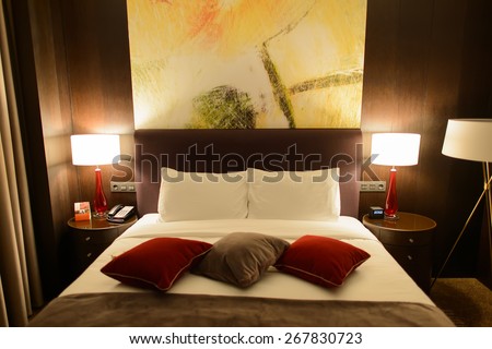 MOSCOW, RUSSIA - MARCH 29, 2015: Hilton bedroom interior. Hilton Hotels & Resorts  is an international chain of full service hotels and resorts and the flagship brand of Hilton Worldwide