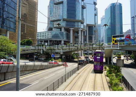 HONG KONG - APRIL 16, 2015: Double-decker trams on street of Hong Kong. Hong Kong tram is the only system in the world run with double deckers.