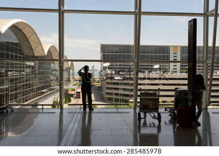 HONG KONG - JUNE 04, 2015: man taking photos in airport. Hong Kong International Airport is the main airport in Hong Kong. It is located on the island of Chek Lap Kok
