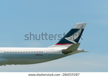 HONG KONG - JUNE 04, 2015: fin of Cathay Pacific aircraft landing. Cathay Pacific is the flag carrier airline of Hong Kong, with its head office and main hub located at Hong Kong International Airport