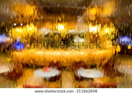 Food court in business lounge through glass wall with waterfall