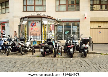PARIS, FRANCE - AUGUST 09, 2015: modern and vintage motorbikes parked in the street of Paris. Paris, aka City of Love, is a popular travel destination and a major city in Europe