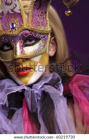 pretty young lady in violet half mask, may be use for joker concept