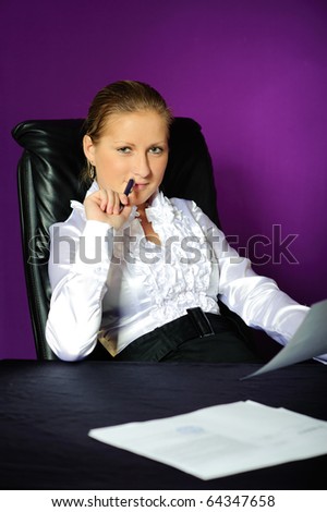 assured business woman sit in big black armchair, isolated on violet background