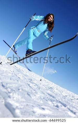 happy young skier in blue sport cloth, good use for winter sports cards and posters