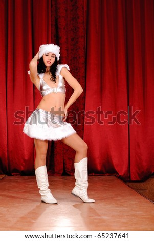 young girl dancing on stage in silver christmas clothing