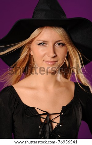 Young mysterious fashion witch isolated on violet background