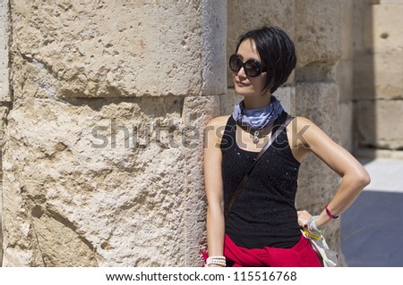 woman leaning on marble column