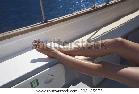 a woman in sun tan on a boat