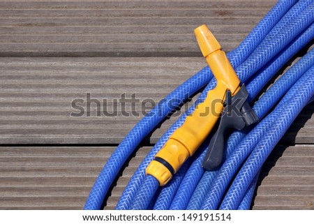 Blue water hose with a yellow nosel