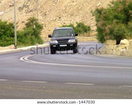 SUV driving around a bend