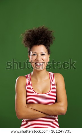 Happy African woman with hands folded over a green background