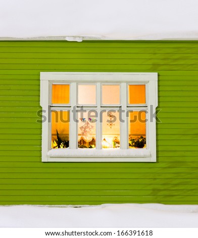 Beautiful window on a wood house with christmas decorations