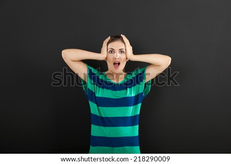 Woman in panic in front of a chalkboard, with copyspace for the designer
