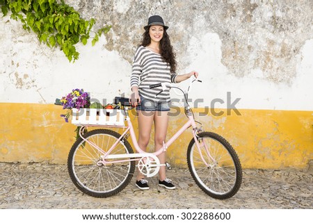 Female tourist living like a local, with her bicycle after buying fresh vegetables