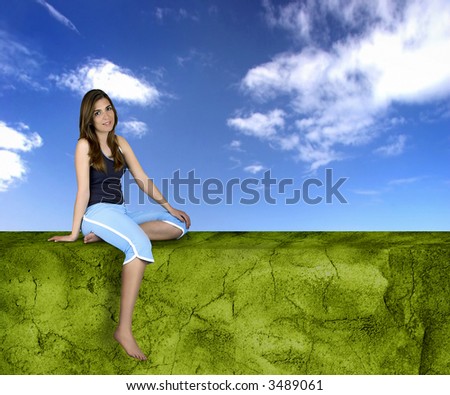 Beautiful athletic woman with different poses seated on a green wall