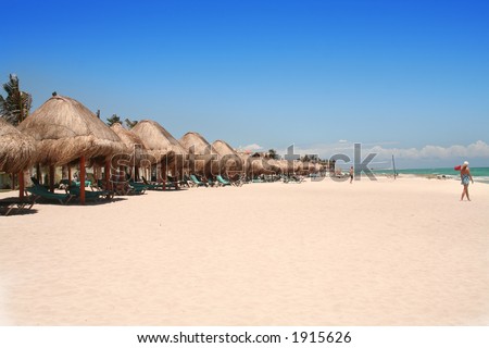 lounge chairs with thatch cover on the beach..space for writing