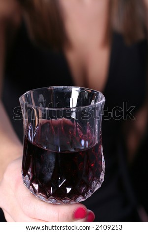 Woman offering a drink of wine
