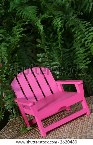 Hot pink adirondack chair with lush foliage background