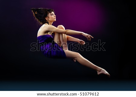 The portrait of a beautiful lady wearing a violet dress and zero gravity