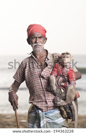 Portrait of an Indian old man with monkey