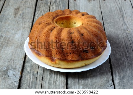 Homemade cake on a white plate on a gray wooden table