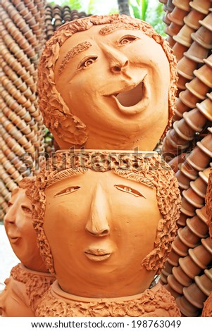 PATTAYA, THAILAND -  JUNE 08, 2014: The strange pots sculpture look like human face in Nong Nooch tropical garden in Pattaya, Thailand. More than 2000 visitors daily