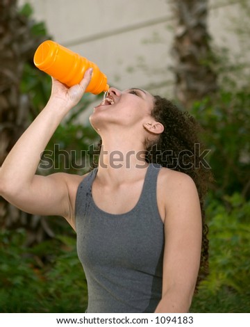 Young Latina Drinking from Orange Sports Water Bottle
