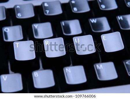 The word True spelled out on a computer keyboard. Only the keys forming True are in focus.
