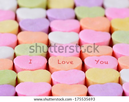 Closeup of the words I Love You spelled out on candy hearts.  The hearts are arranged in straight rows only candies have words. Shallow depth of field. Great for Valentine's Day projects.