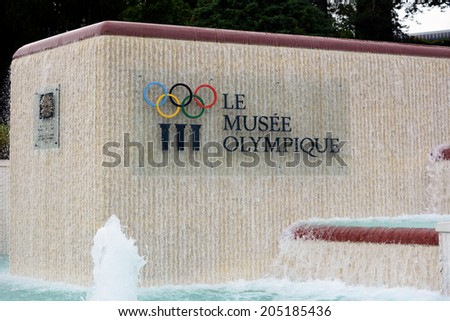 LAUSANNE, SWITZERLAND - JULY 5, 2014: Fountain and Sign at the Olympic Museum. The Museum has more than 10,000 pieces and hosts over 250,000 visitors a year.