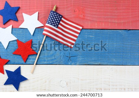 High angle shot of an American Flag and fabric stars on a red, white and blue picnic table. With copy space, perfect for 4th of July and Memorial Day projects.