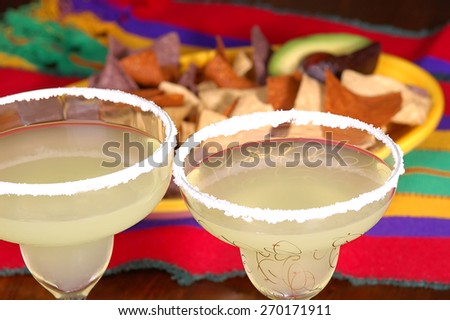 Margaritas with platter of corn chips on Mexican table cloth. Ready for a Cinco de Mayo project.