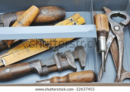 Closeup of a tool tray with assorted old tools