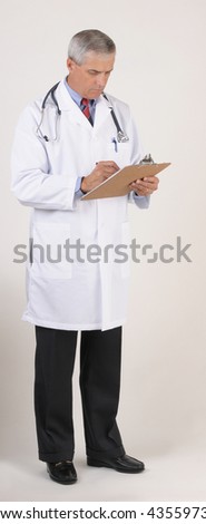 Smiling Middle Aged  Male Doctor in Lab Coat with Stethoscope Writing on chart - gray background