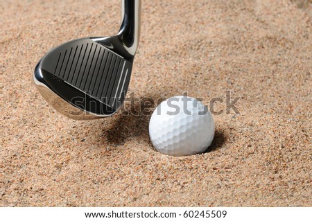 Golf Ball in Trap with Sand Wedge about to strike the golfball. Close up in horizontal composition with copy space.
